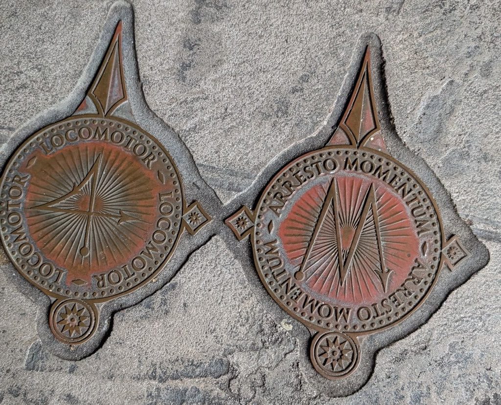 Locomotor and Arresto Momentum medallions set into the pavement