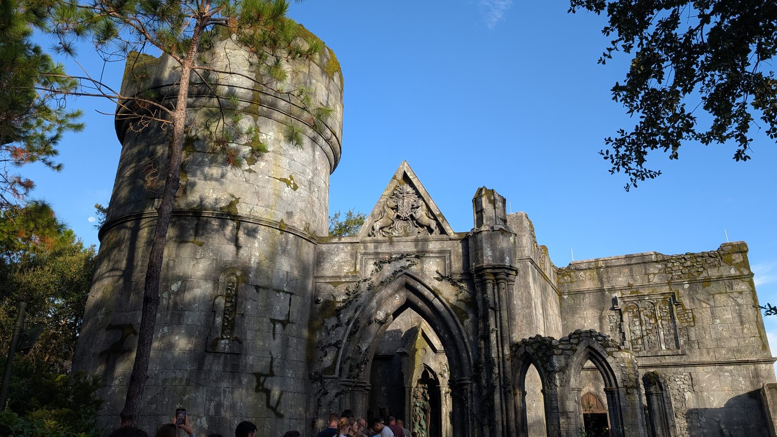 The ruined abbey entrance on the Motorbike Adventure queue path in Hogsmeade.