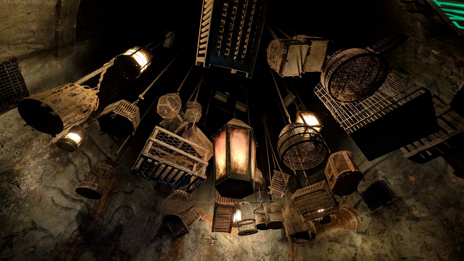 Hanging cages and lanterns above the covered section of the queue.