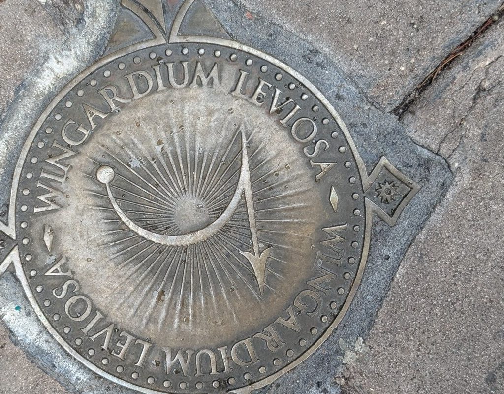 The bronze medallion for Wingardium Leviosa, engraved with the swish and flick.